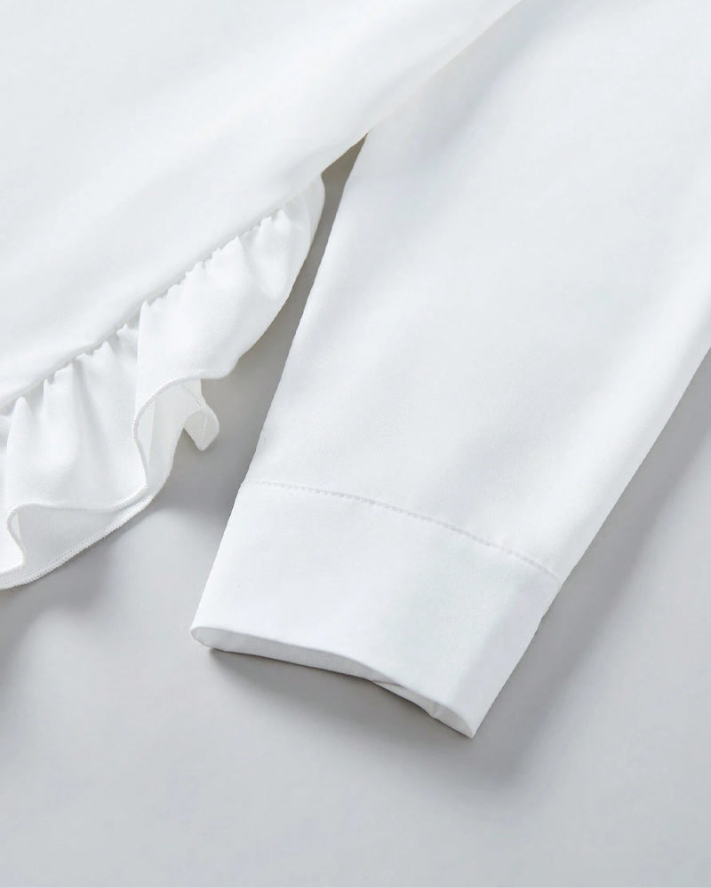 Chemise unie à volants et revers