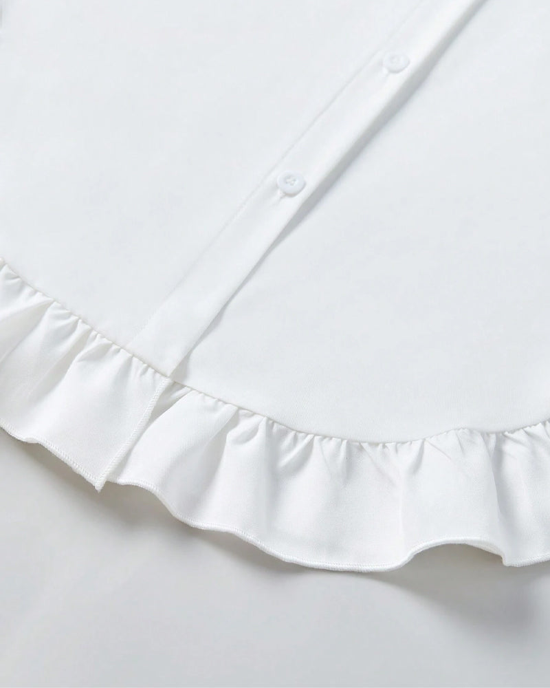 Chemise unie à volants et revers